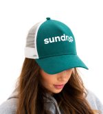 A green and white custom trucker cap with a mesh back and a logo on the front.