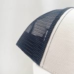 A white trucker cap featuring a blue mesh back. The cap has a structured front panel and visible stitching.