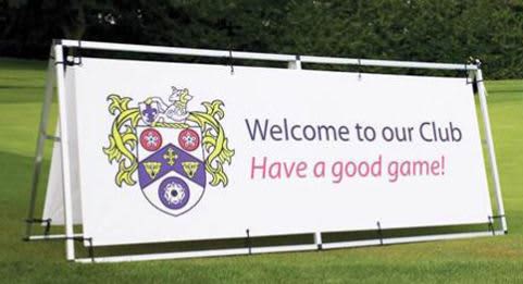 A double-sided vinyl banner with an aluminium stand, featuring a club crest and welcoming message, set on green grass. Double Sided Vinyl Banner with Aluminium Stand 850mm x 2000mm - Image 1