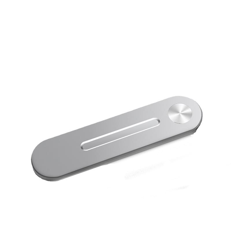 A silver magnetic laptop side mount clip with a rounded edge and a circular button. It has a minimalist design. A silver magnetic laptop side mount clip with a rounded edge and a circular button. It has a minimalist design.