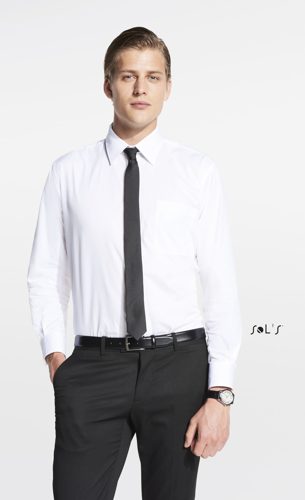 A man in a white shirt and black tie stands confidently, wearing black trousers and a watch. The image features a logo. Tie slim style GATSBY - Image 1