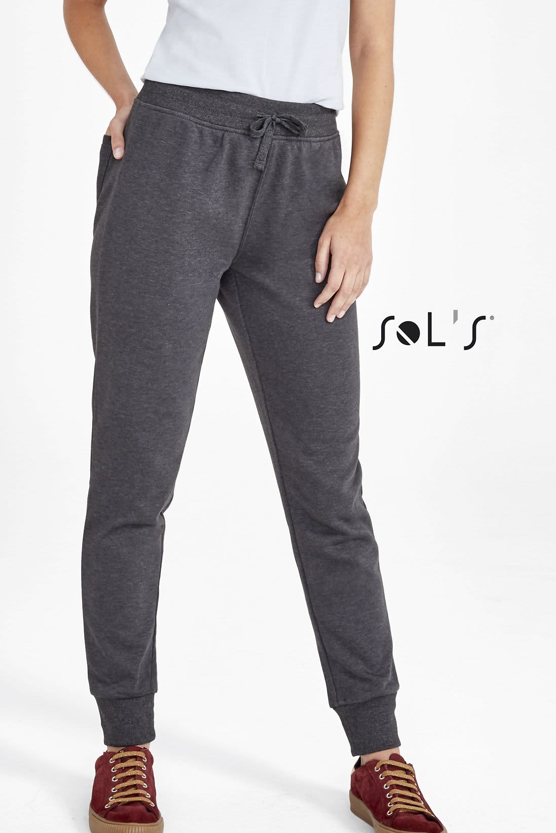 Slim fit women's track suit pants in grey, featuring an elastic waistband and cuffs, with a logo present. Track suit pants women's slim fit JAKE - Image 1