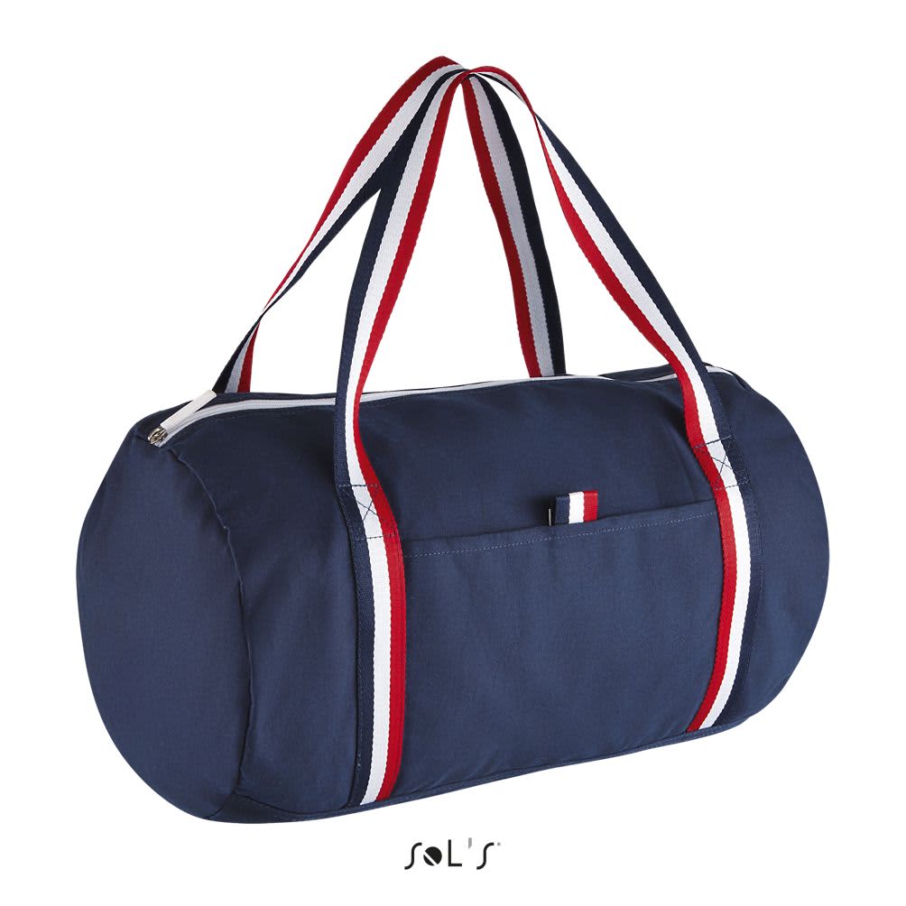 A navy duffel bag with red and white striped handles, featuring a front pocket and a zip closure. ODEON DUFFEL BAG - Image 1