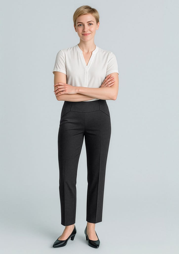 A woman wearing black slim leg pants and a white top, smiling with arms crossed. The pants feature a bandless design. Womens Cool Stretch Bandless Slim Leg Pant - Image 1