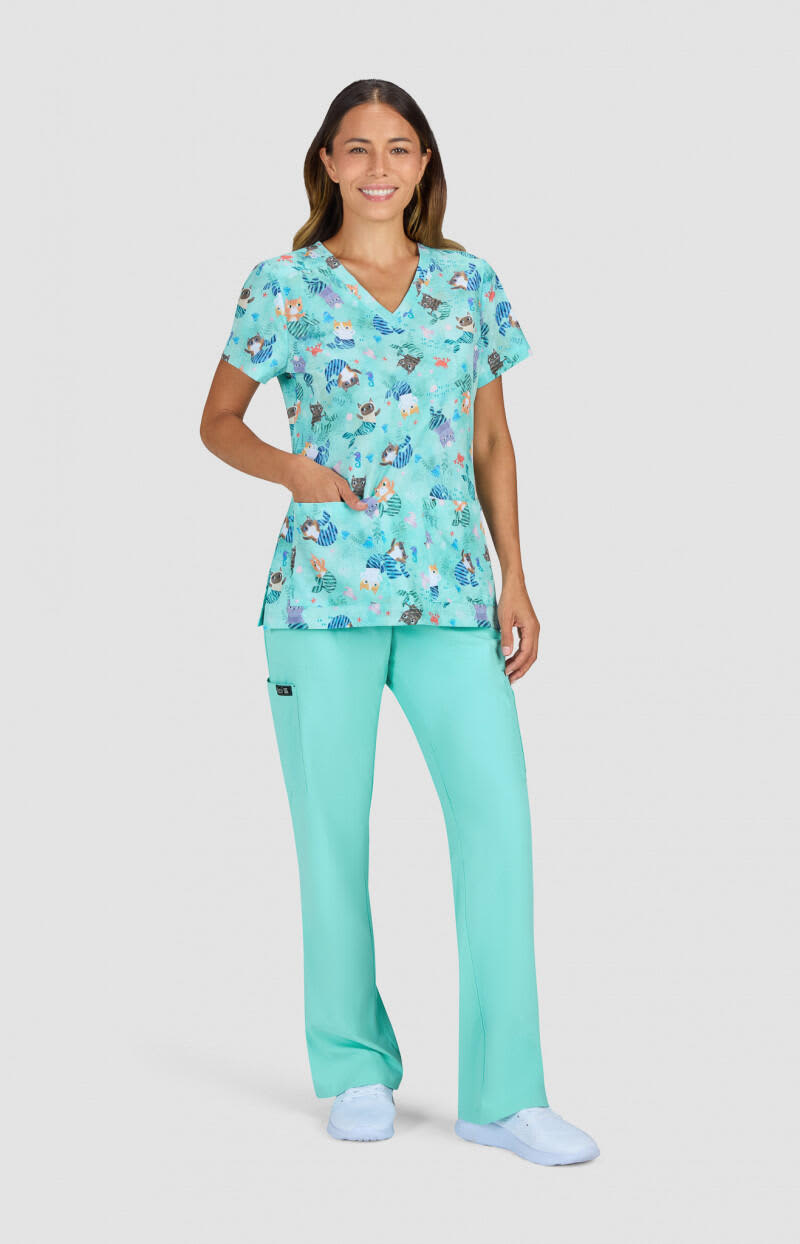A floral print top in shades of teal, paired with matching teal pants, worn by a woman. The outfit includes a logo. Rosalie Top (Print) - Image 1
