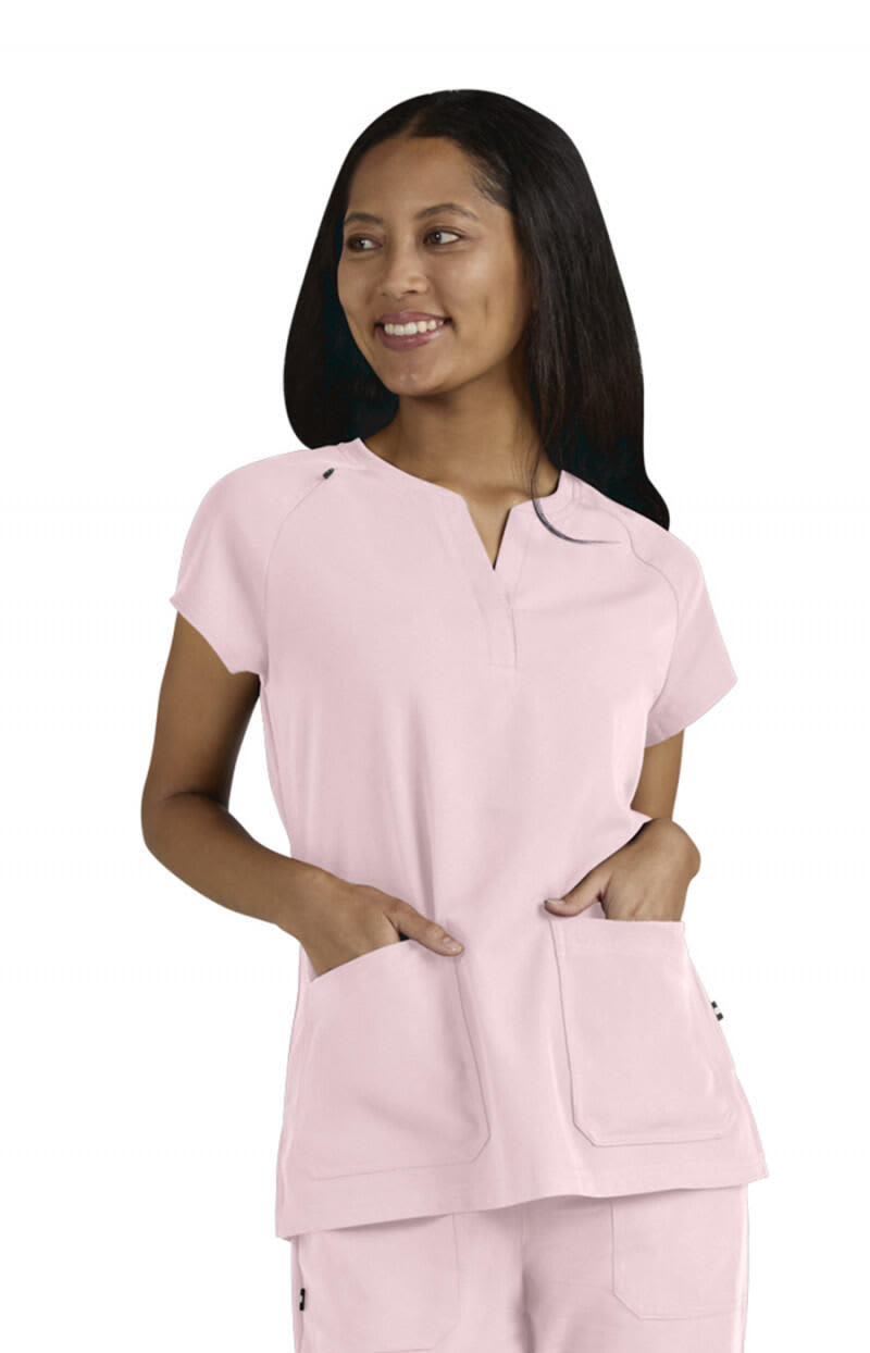 A medical top in soft pink featuring a V-neck, short sleeves, and front pockets, showcasing a branding logo. We Have Heart Top - Image 1