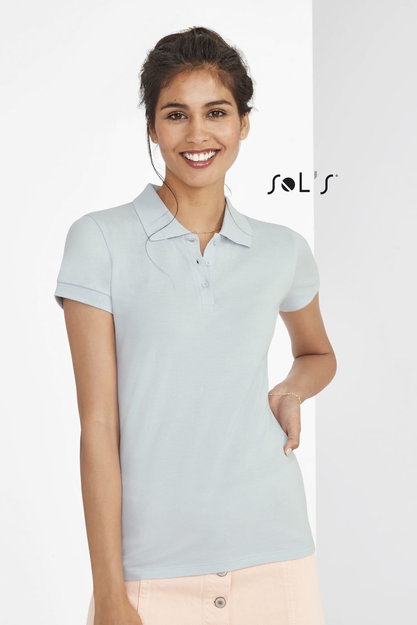 A women's polo shirt in light blue, made from 100% cotton pique, featuring a logo on the upper left. Polo shirt women's 100% cotton Pique PERFECT - Image 1