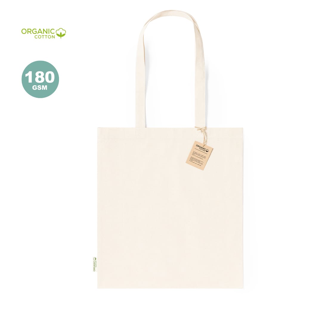 A plain cream tote bag made from organic cotton with a tag. It features long handles for carrying. Fizzy Bag - Image 1