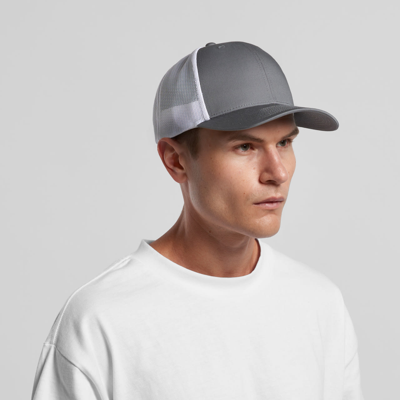 A grey trucker cap with a white mesh back, featuring a logo on the front. Casual style with a structured fit. Mesh Contrast Trucker Cap - Image 1