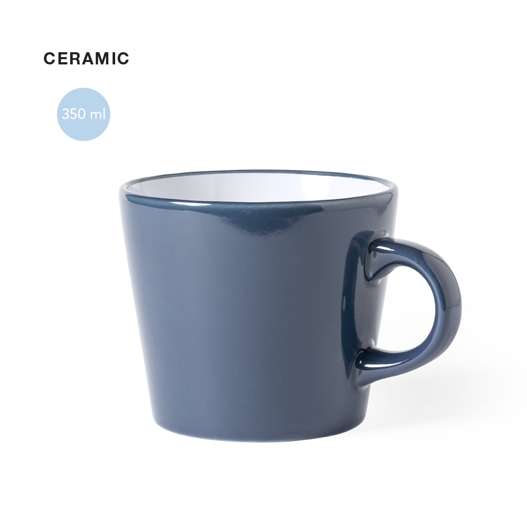 A ceramic coffee mug in a navy blue colour with a white interior, featuring a single handle. Kario Mug - Image 1