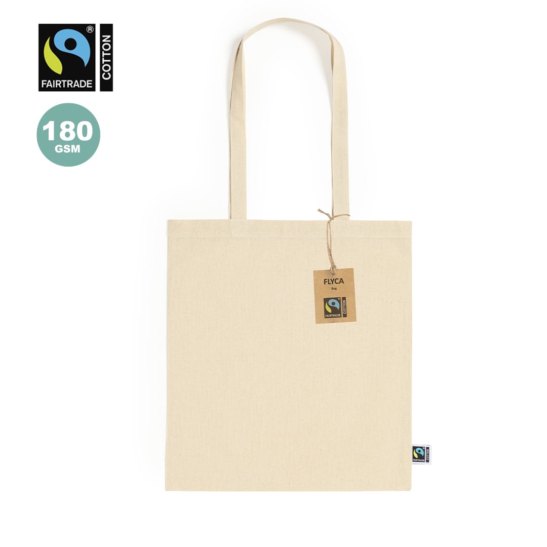 A cream tote bag made of Fairtrade cotton with a tag and a logo. It features long handles and a simple design. Flyca Fairtrade Bag - Image 1