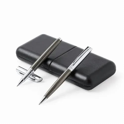 A set of two metallic pens in a textured grey finish, placed on a sleek black case. Williams - Image 1