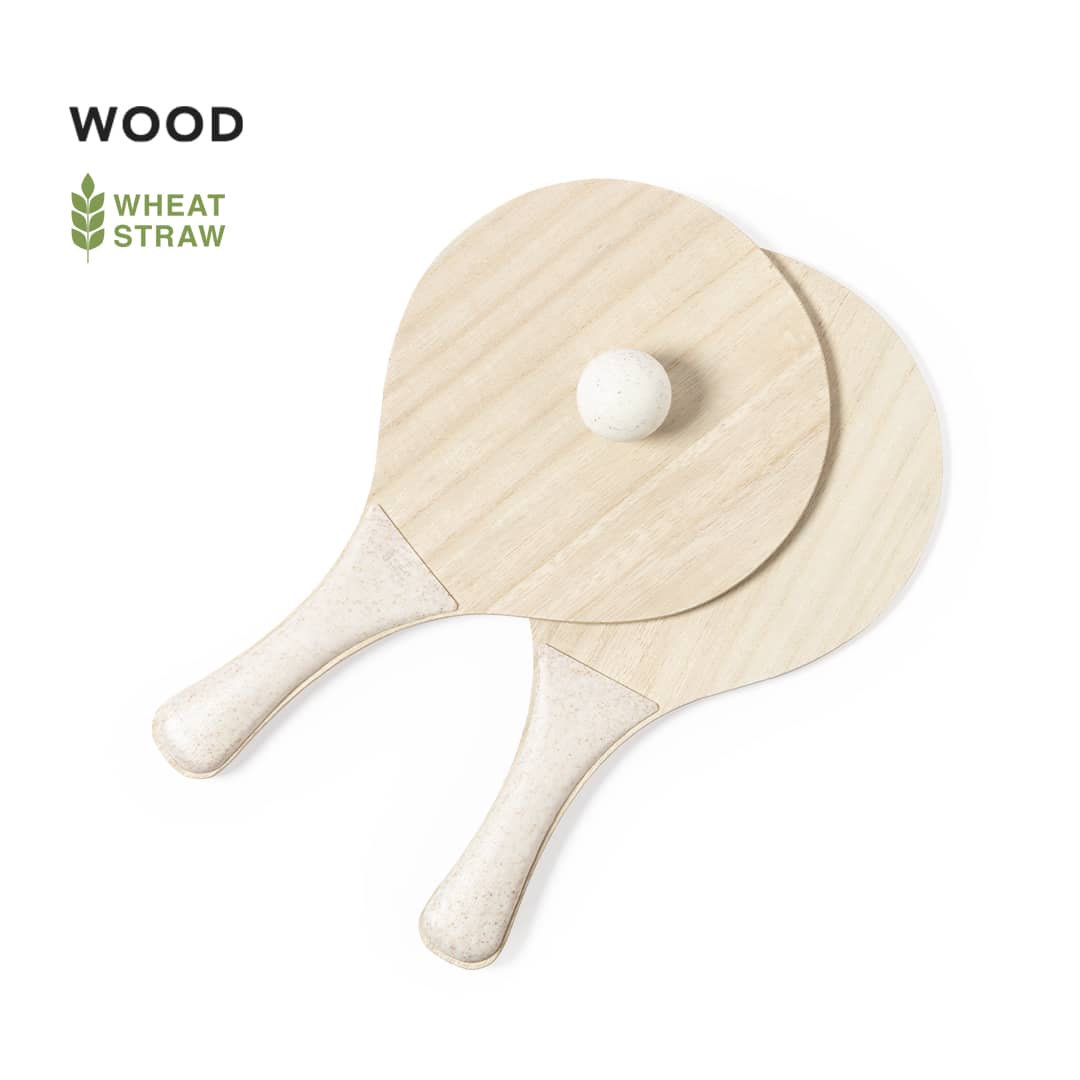 Two wooden beach rackets in a natural hue, featuring smooth handles and a central ball. The product has a logo. Saiker Beach Rackets - Image 1