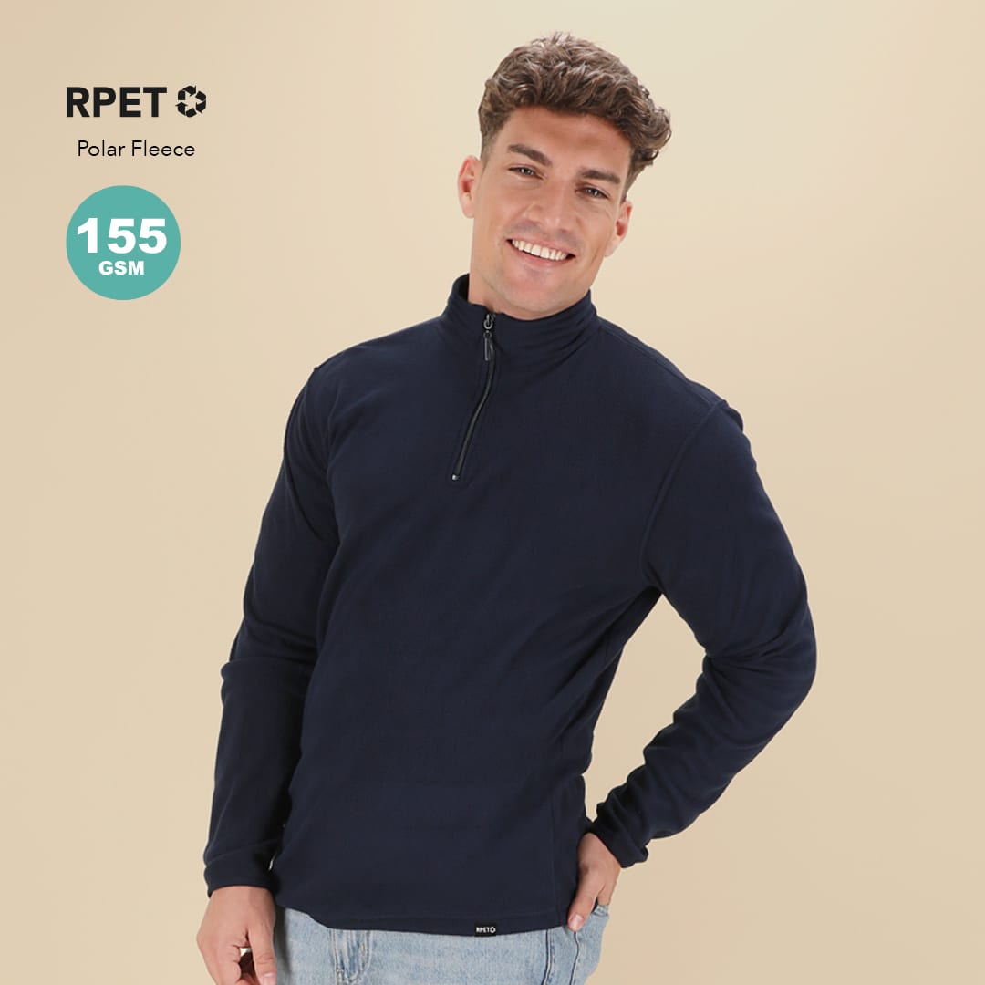 A navy blue polar fleece jacket with a quarter zip, featuring a logo, worn by a smiling male model. Mesiox Polar Fleece - Image 1