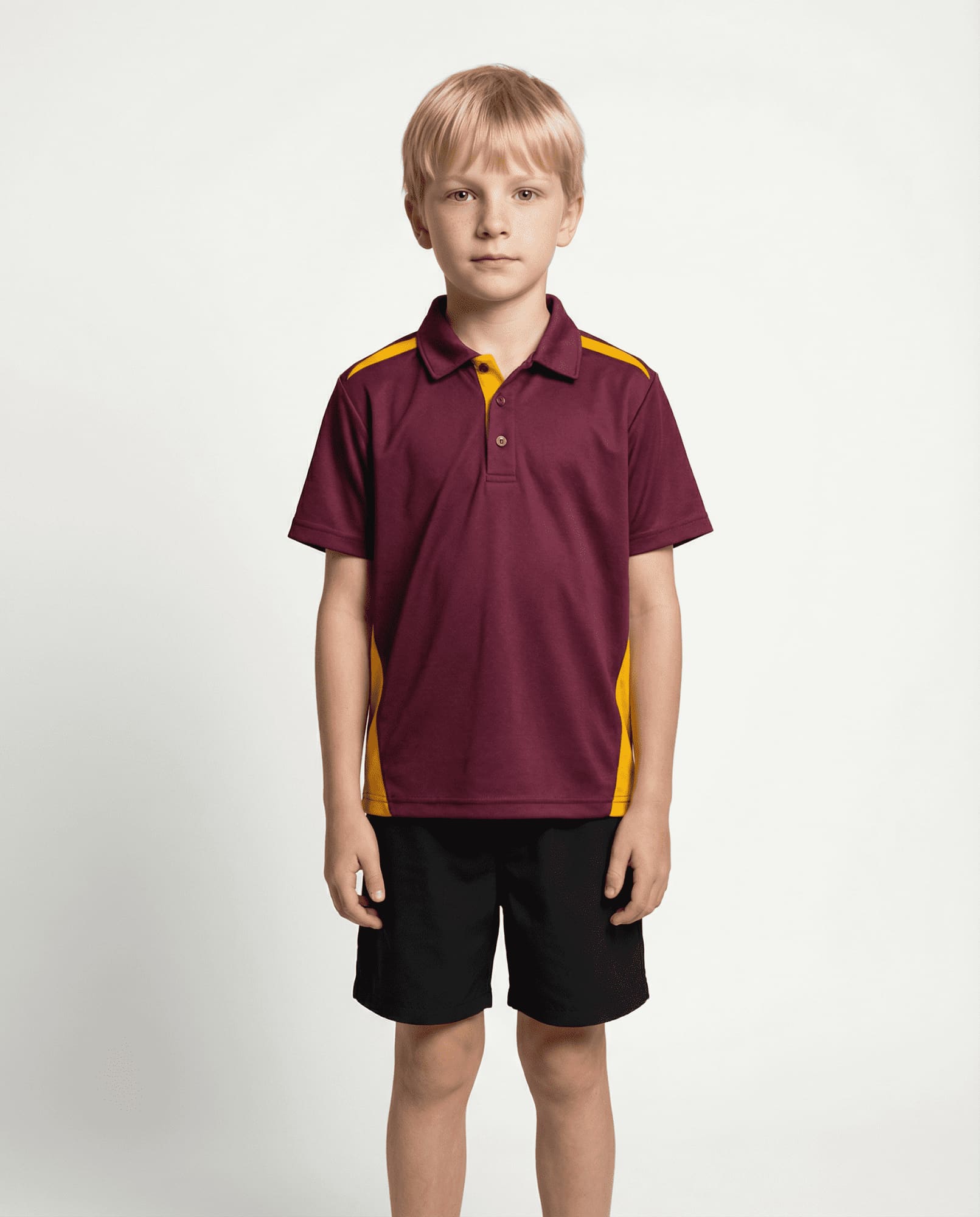 A child wearing a maroon and yellow polo shirt paired with black shorts, standing against a plain background. PATERSON KIDS POLOS RUNOUT - Image 1