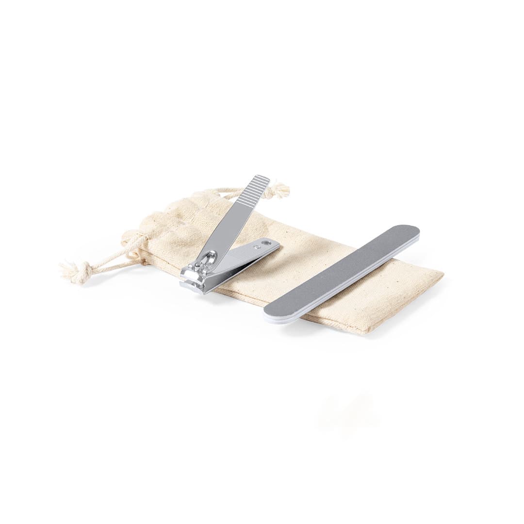 A silver nail clipper and nail file on a beige pouch. The set is designed for personal grooming. Kilian Manicure Set - Image 1