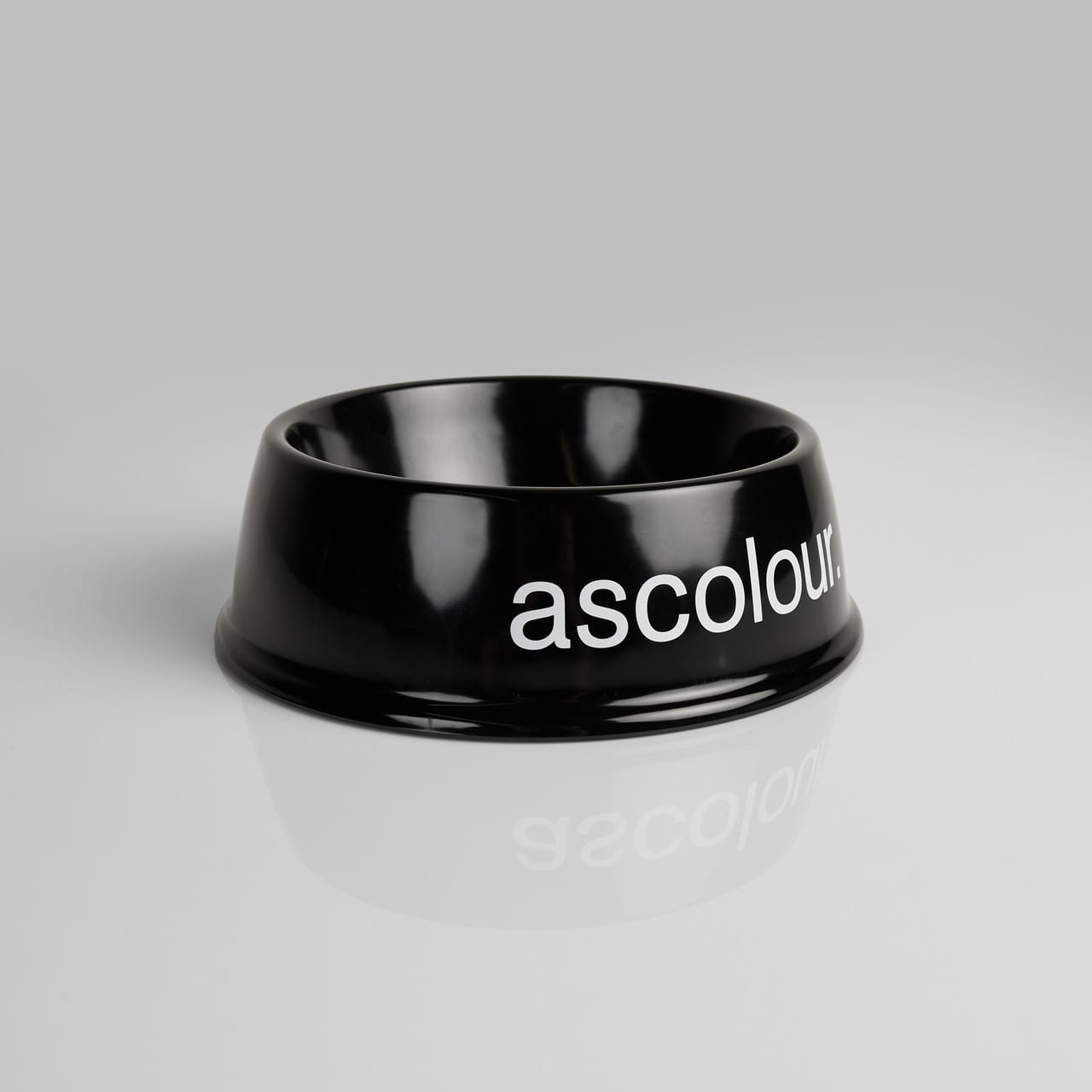 A black pet bowl with a glossy finish and a branding logo. Ideal for pet accessories. ASC Pet Bowl - Image 1