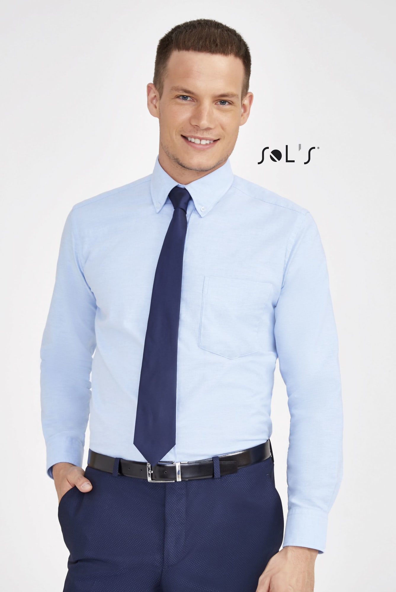 A light blue long sleeve oxford shirt with a pocket, paired with a dark tie and belt, worn by a model. Business shirt BOSTON LONG SLEEVE OXFORD MEN'S SHIRT - Image 1