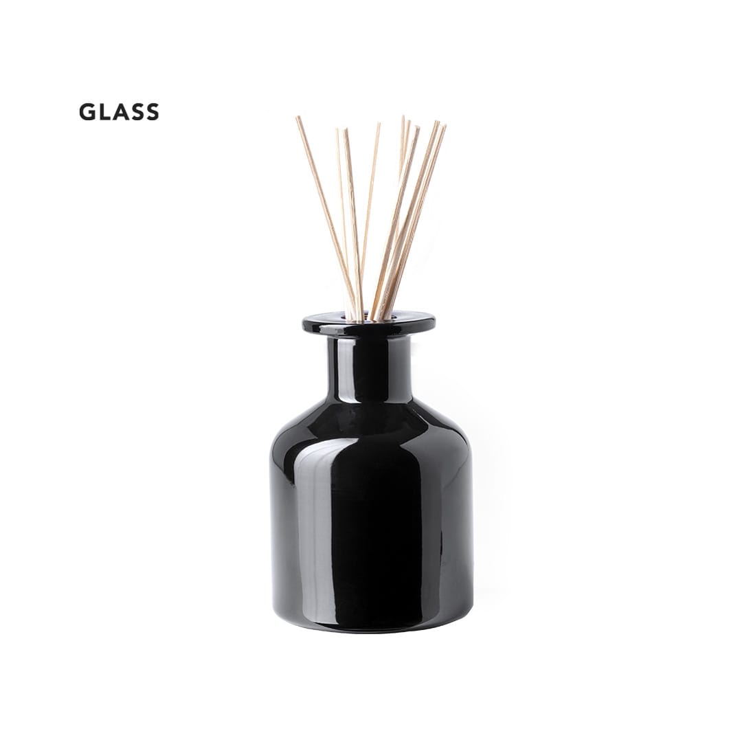 A black glass aromatic diffuser with wooden reeds protruding from the top. It has a sleek, rounded design. Kenet Aromatic Diffuser - Image 1