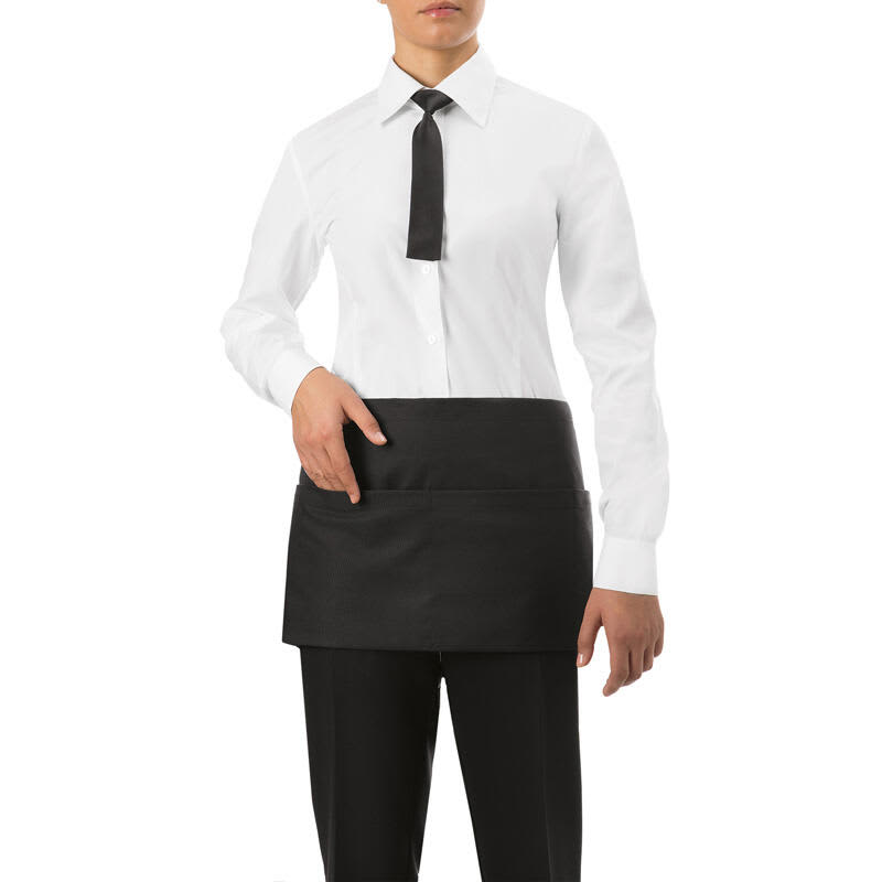 A black waist apron is worn by a person in a formal outfit, featuring a pocket and a stylish design. Charlie Waist Apron - Image 1