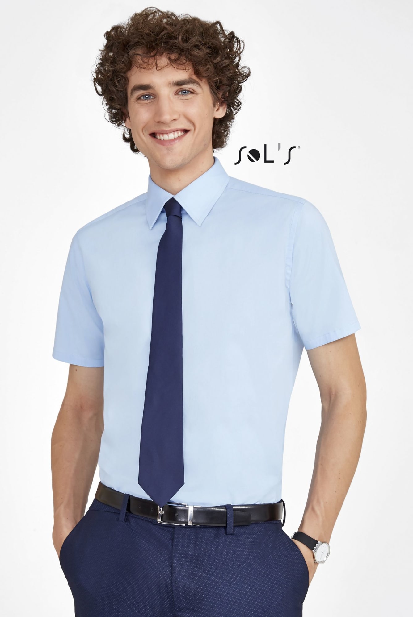 A light blue short sleeve men's shirt, paired with a navy tie and dark trousers, featuring a logo. Business shirt BROADWAY SHORT SLEEVE STRETCH MEN'S SHIRT - Image 1
