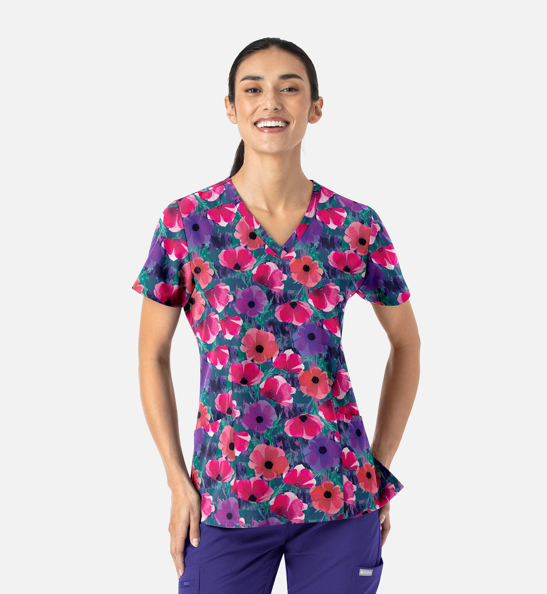 A vibrant women's V-neck top featuring a floral print in purple, pink, and green hues. It includes a logo. Prints Womens V-Neck Print Top - Image 1