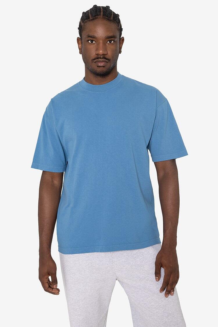 A crewneck t-shirt in a vibrant blue colour, featuring short sleeves and a relaxed fit, displayed on a model. Short Sleeve Garment Dye Crewneck Tee - Image 1