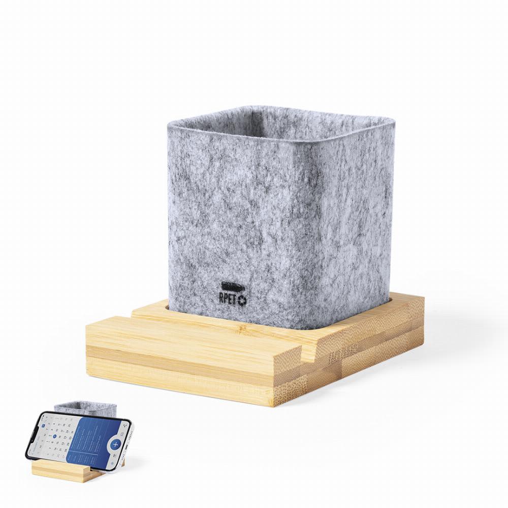 A grey felt plant pot with wooden base, accompanied by a smartphone placed on a felt mat. Firdex - Image 1