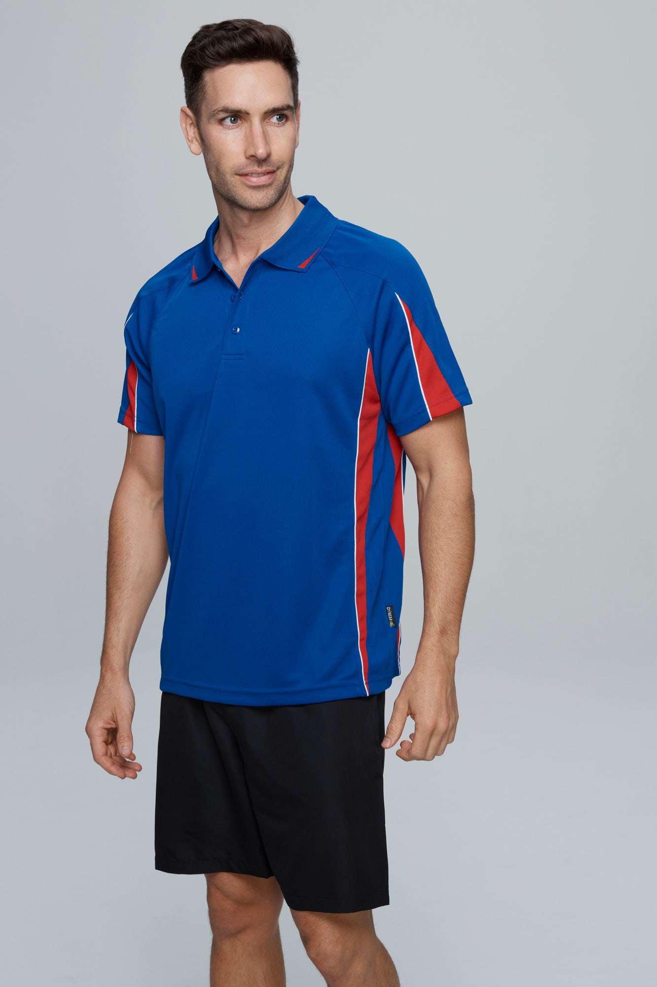 A blue polo shirt with red accents displayed on a model wearing black shorts. The shirt features a logo. EUREKA MENS POLOS - Image 1