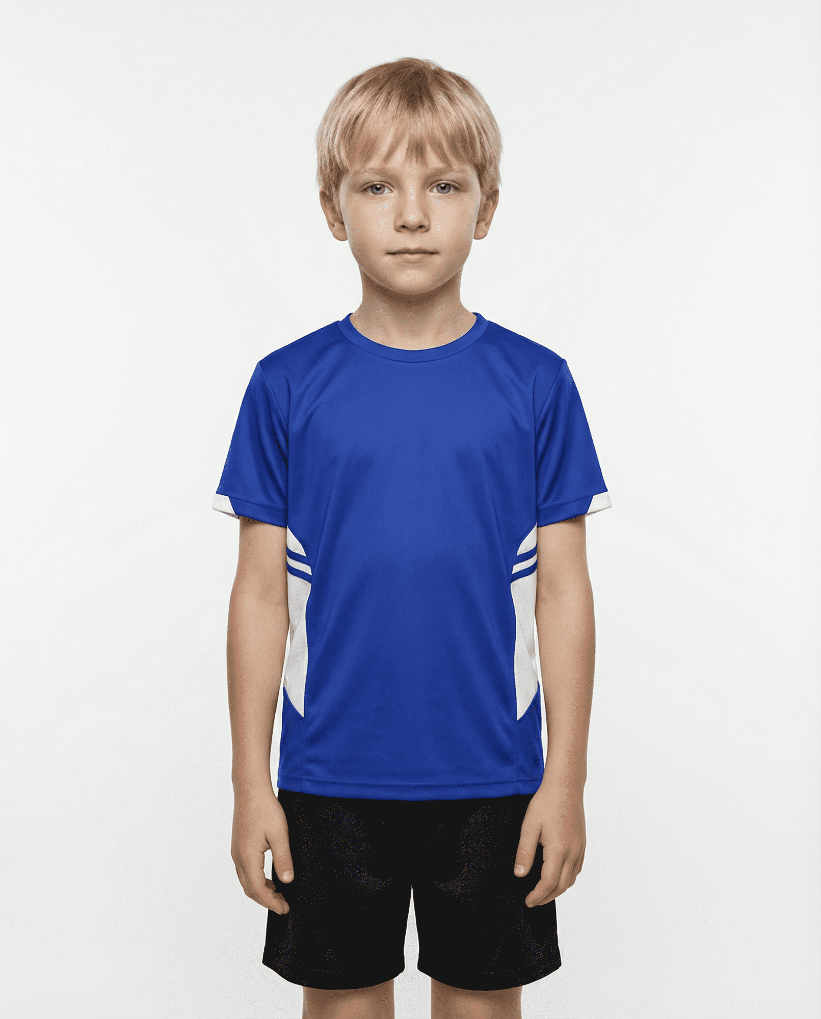 A boy wearing a blue T-shirt with white accents, paired with black shorts. The shirt has a logo. TASMAN KIDS TEES - Image 1