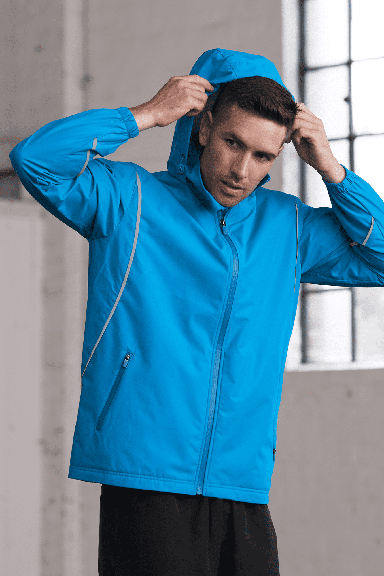 A blue men's jacket featuring a hood and zipper, with a sporty design and reflective detailing. BUFFALO MENS JACKETS RUNOUT - Image 1