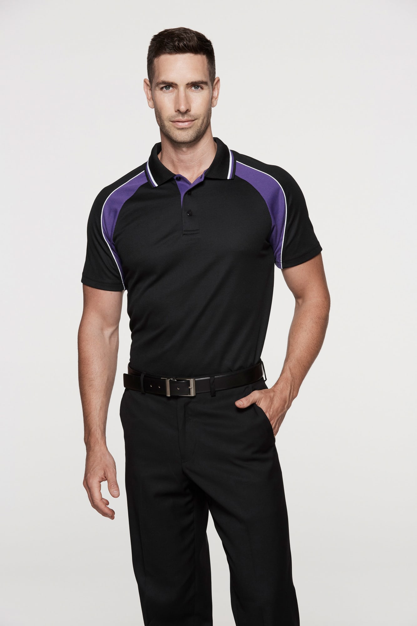 A model wearing a black polo shirt with purple detailing, paired with black trousers. The shirt features a logo. PANORAMA MENS POLOS - Image 1