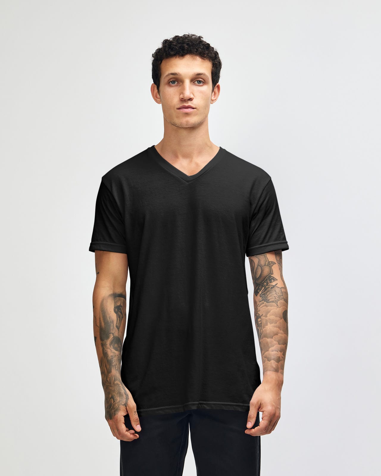 A black unisex V-neck T-shirt displayed on a model, featuring short sleeves and a logo. American Apparel CVC Unisex V-neck T-shirt - Image 1