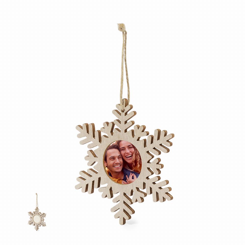 A wooden snowflake-shaped ornament with a circular frame for a photo, featuring a natural wood finish and a hanging string. Jorik - Image 1