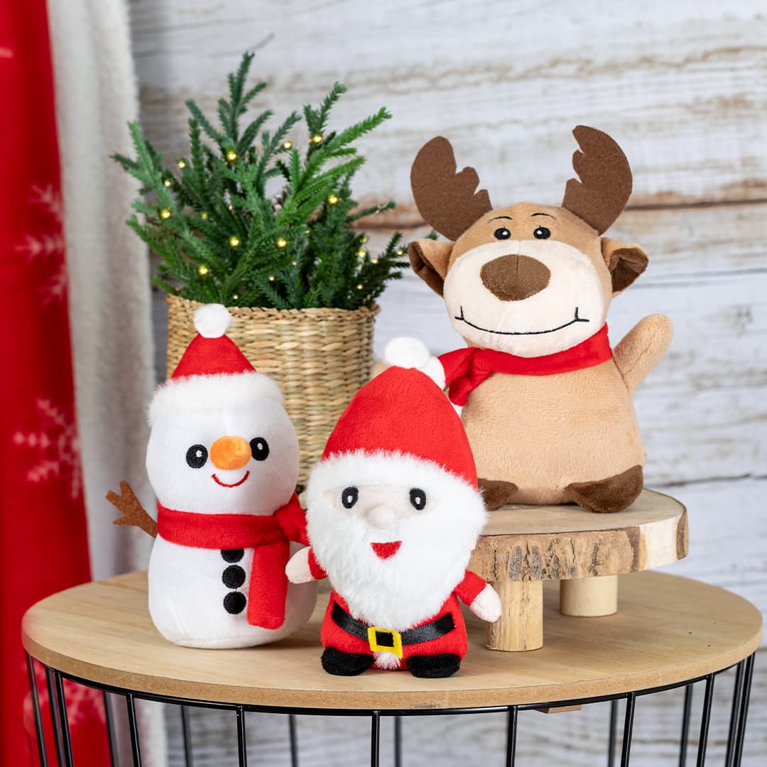 A festive display featuring a snowman, Santa Claus, and a reindeer plush toy, all dressed in holiday attire. Nando - Image 1
