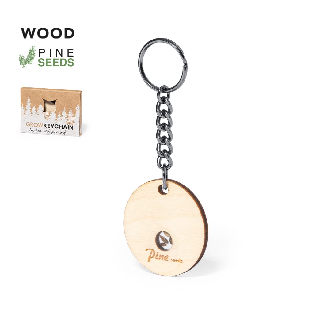 A wooden keyring featuring a circular design, attached to a silver chain, with branding and a seed packaging box. Krusty Seeds Keyring - Image 1
