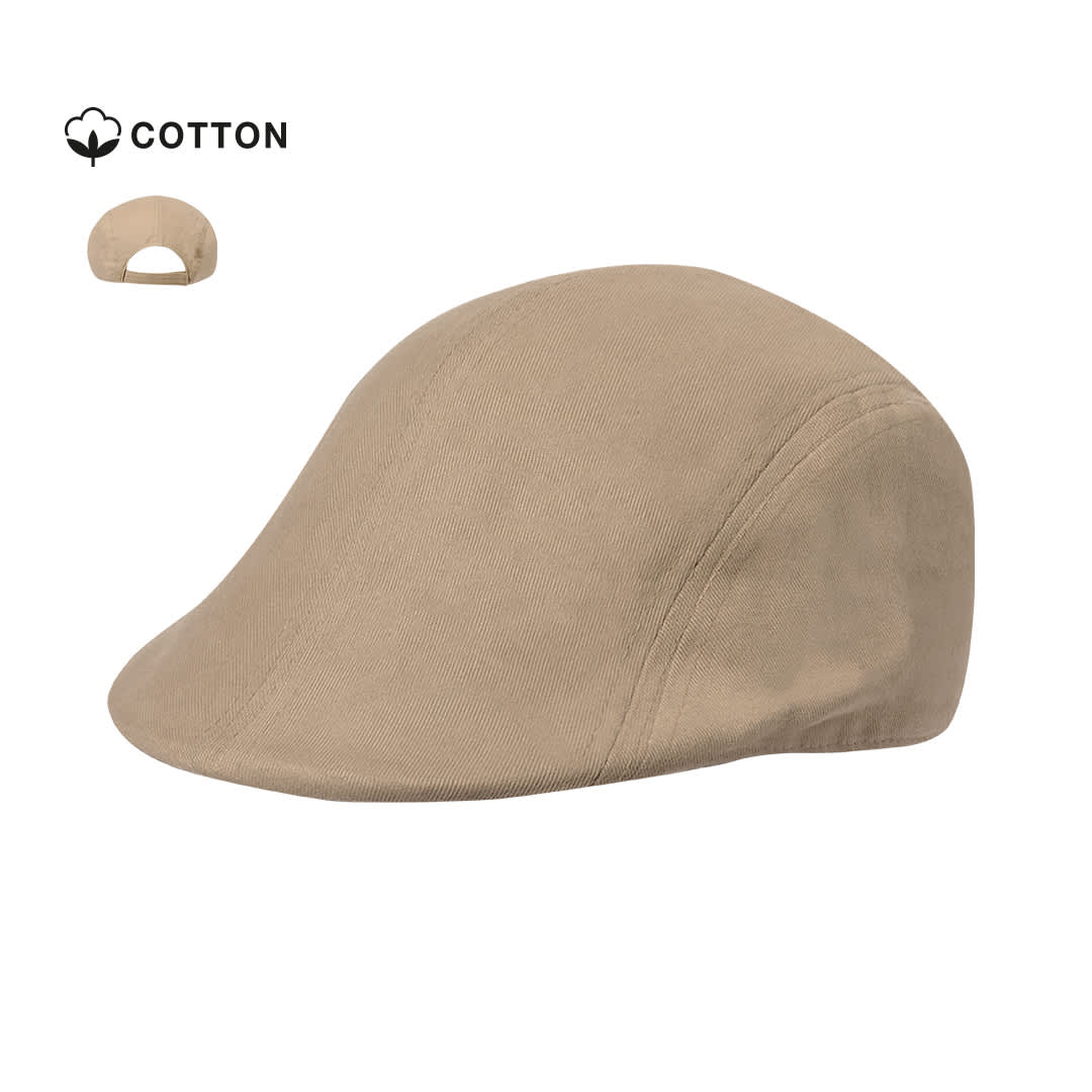 A tan cap made from cotton, featuring a curved brim and a logo on the side. Bruck Cap - Image 1