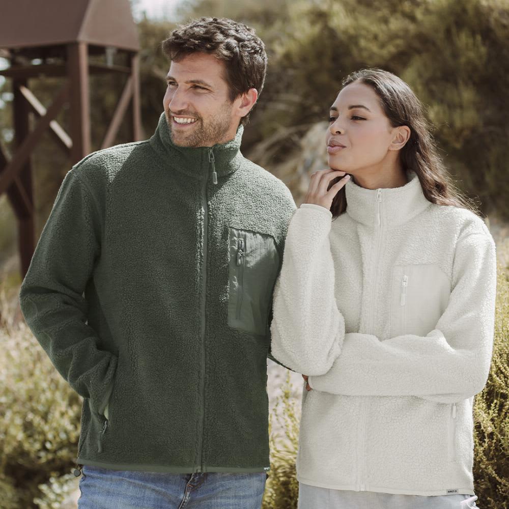 A green fleece jacket and a cream fleece jacket worn by a man and woman outdoors. Both jackets feature zip closures. Killian - Image 1