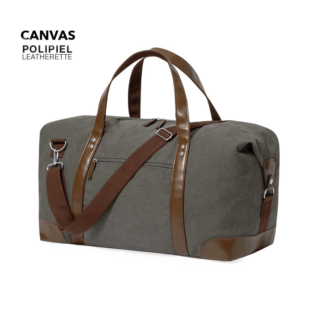 A grey canvas bag with brown leatherette accents and chocolate straps, featuring a zip pocket and a logo. Sharyl Bag - Image 1