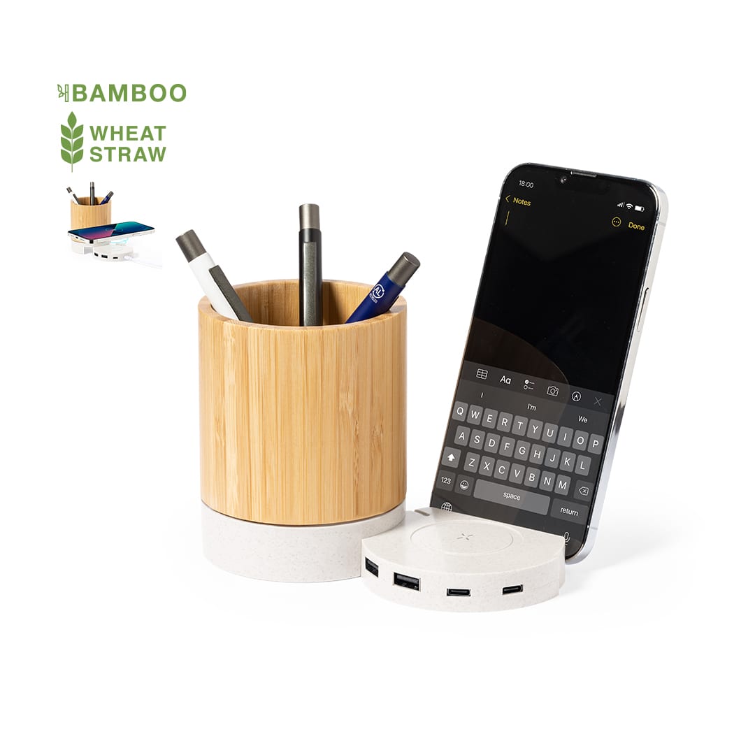A bamboo and wheat straw pencil holder with assorted pens, alongside a smartphone and a white base with USB ports. Birwen Multifunction Pencil Holder - Image 1