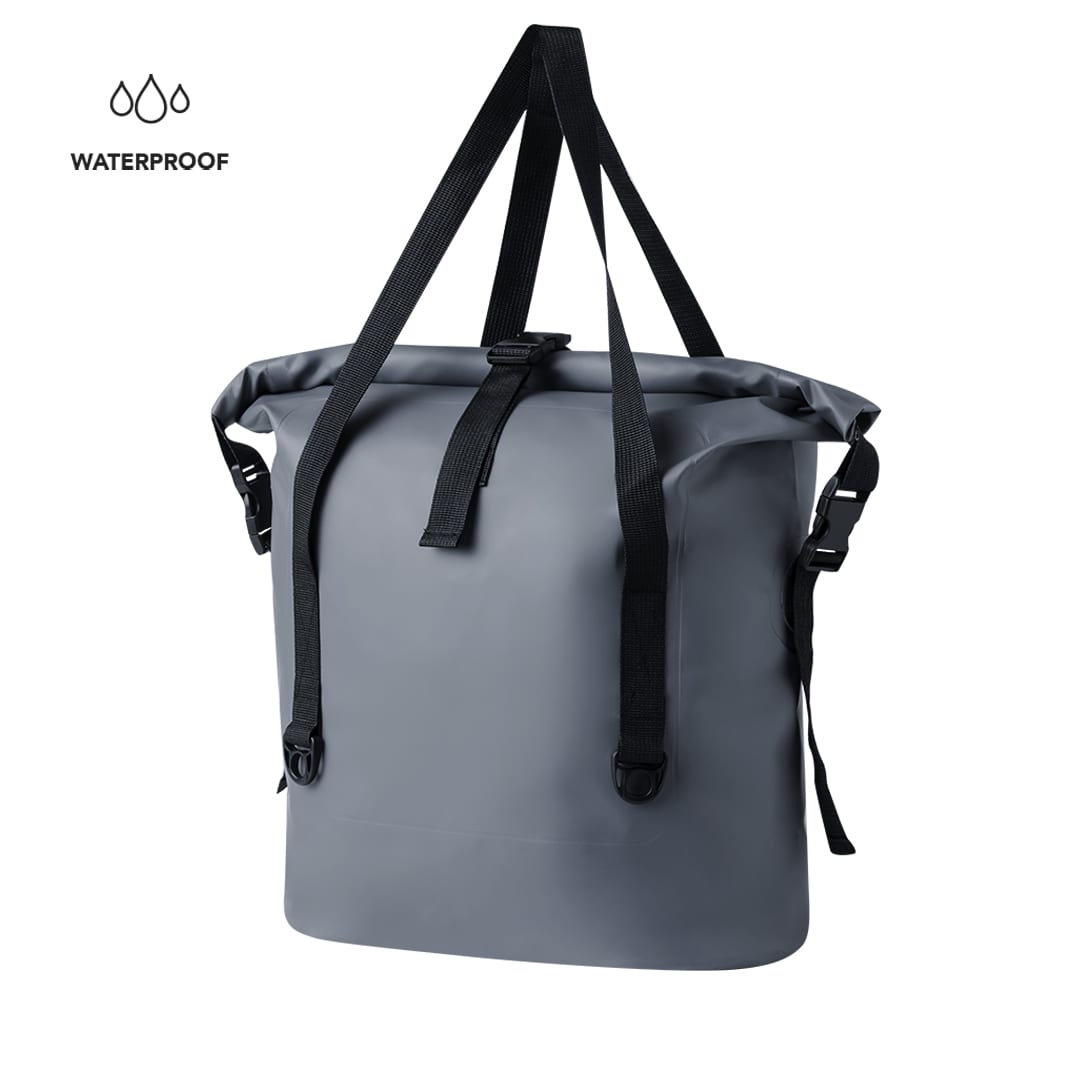 A grey waterproof dry bag with two adjustable straps and a clasp closure. It features a branding logo. Nandora Bag - Image 1