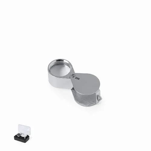 A silver magnifying glass with a 20X lens, positioned above a small black and clear case. Rindex 20X - Image 1