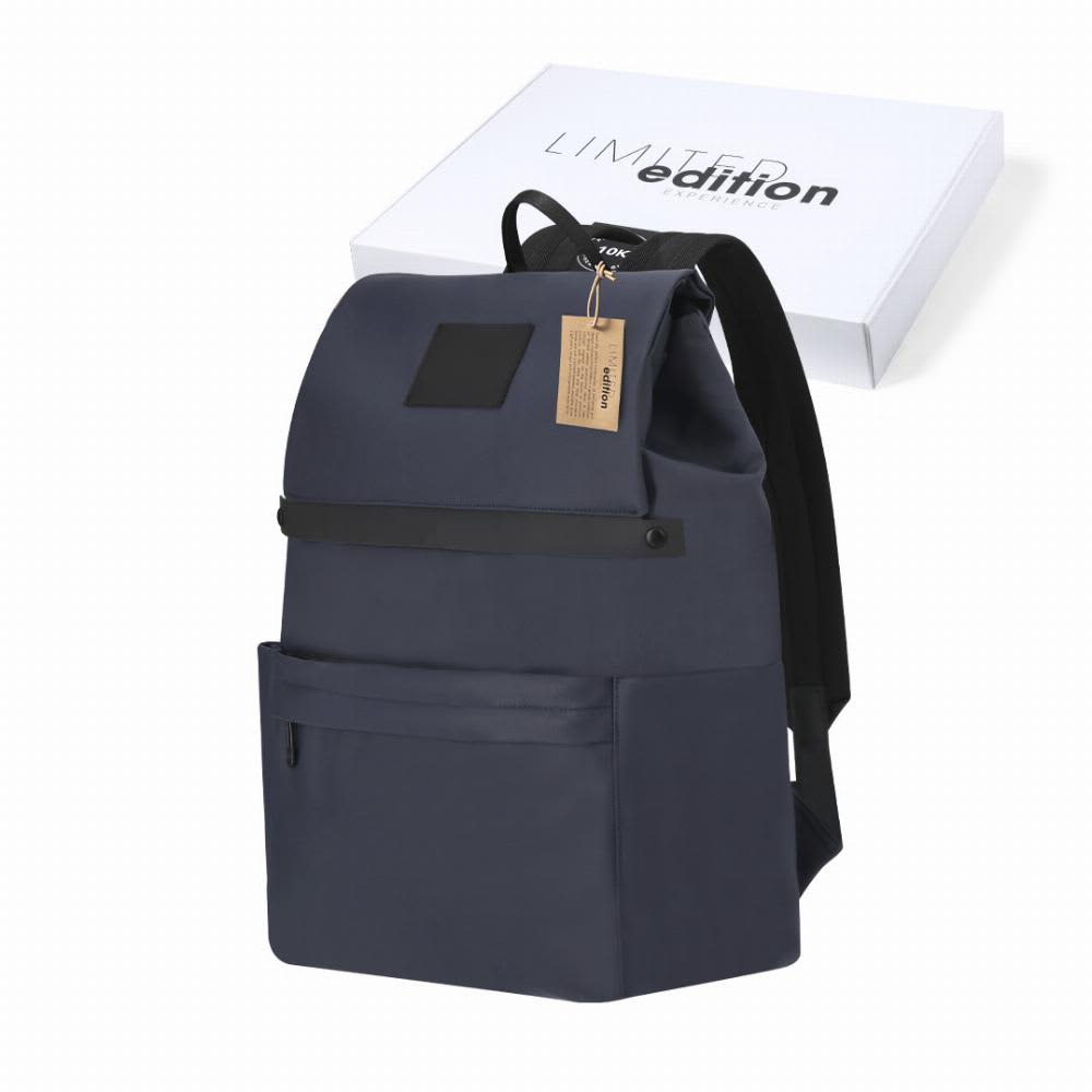 A navy blue backpack with a textured front panel, featuring a label tag and a box in the background. Salkey - Image 1