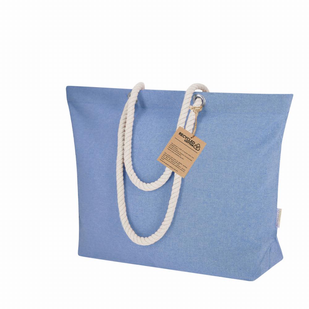 A tote bag in light blue fabric with white rope handles and a tag attached. Coulan - Image 1
