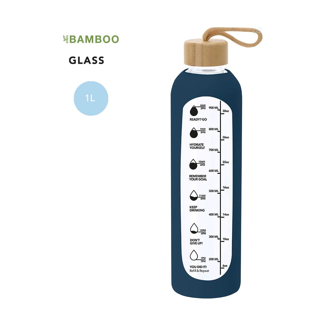 A drink bottle in dark blue glass with a bamboo lid and a measurement scale on the side. Kramex Bottle - Image 1