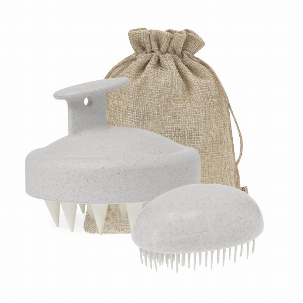 A hair scalp massager in light grey with a handle, alongside a smaller oval massager, packaged in a burlap drawstring bag. Puxar - Image 1