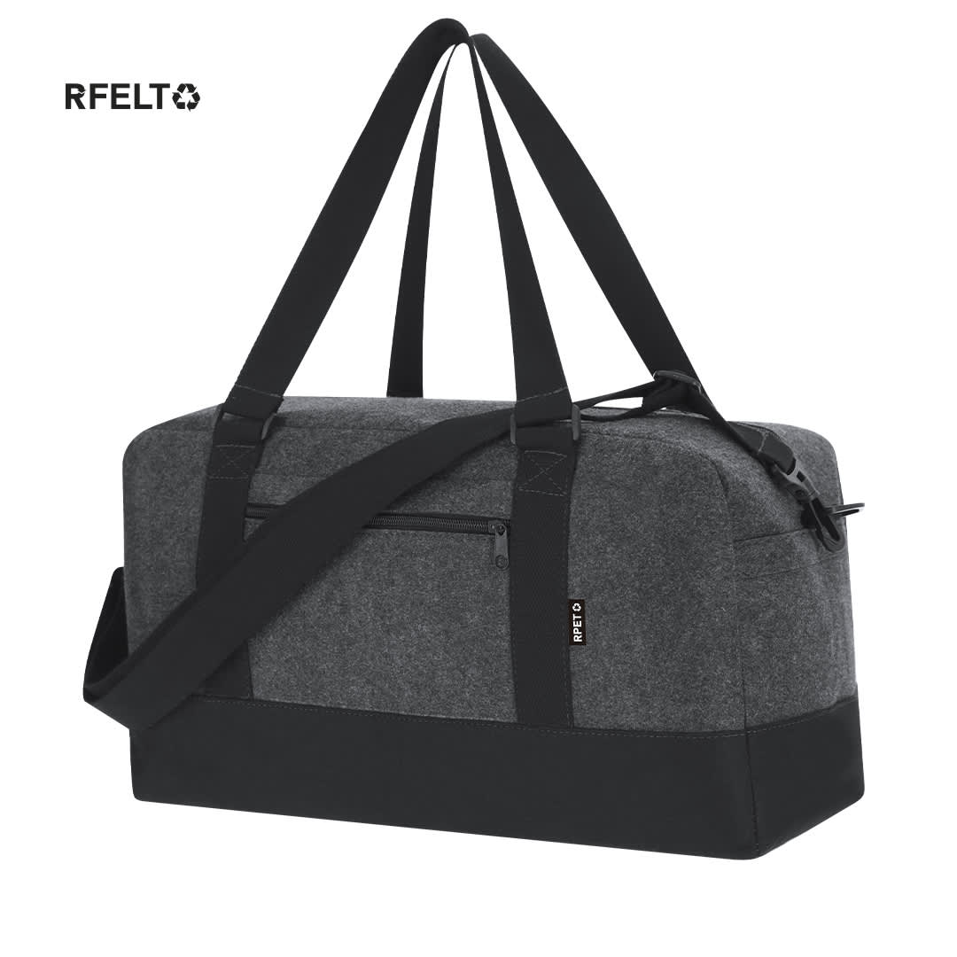 A grey and black duffle bag with adjustable straps and a logo, featuring a front zipper pocket. Yusof Bag - Image 1