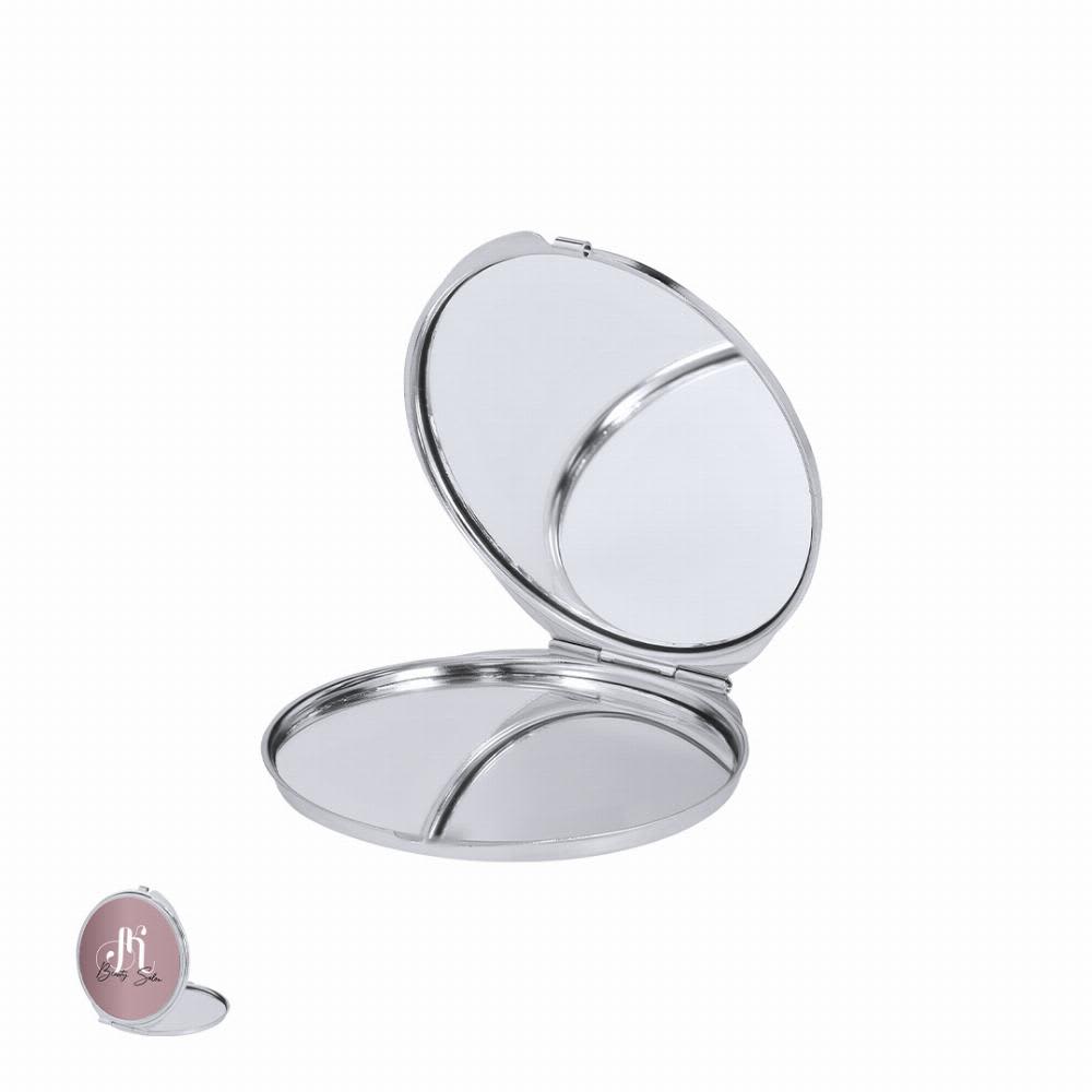 A compact mirror with a silver finish, featuring two reflective surfaces inside an elegantly designed case. Ariela - Image 1