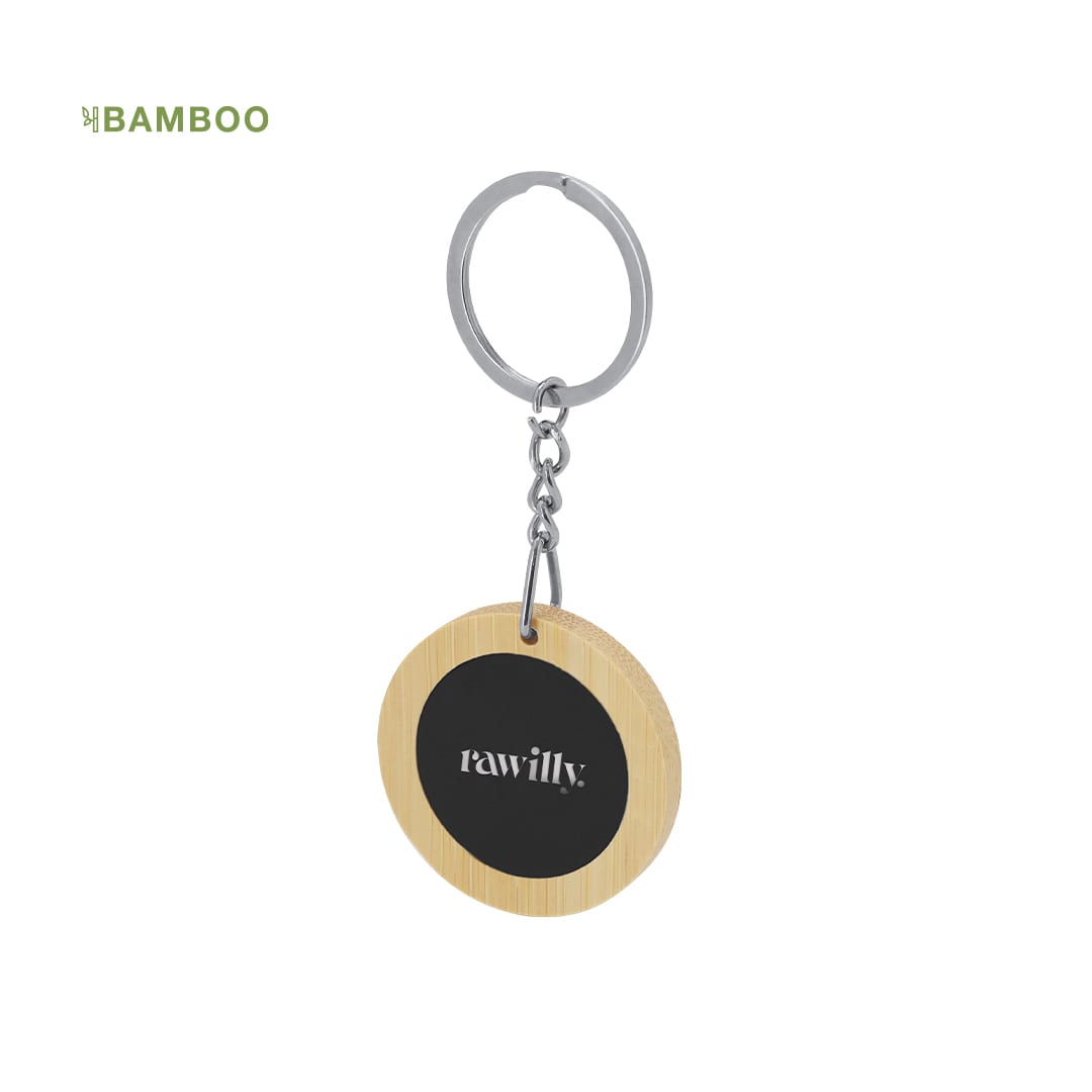 A bamboo keyring featuring a circular wooden charm with a black centre and a silver metal keyring attachment. Khozax Keyring - Image 1
