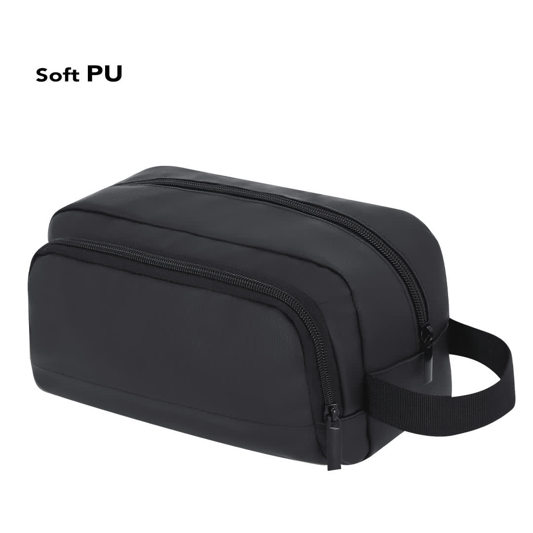 A black toiletry bag made of soft PU, featuring dual zip compartments and a side handle for easy carrying. Besner Beauty Bag - Image 1